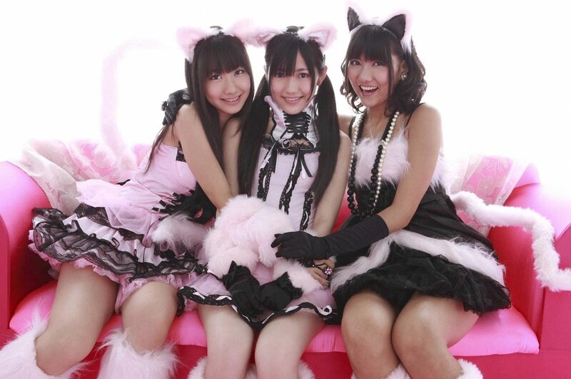 Three girls in cat costumes