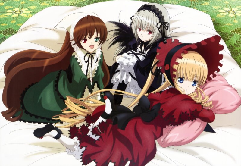 Three girls in dresses on a bed