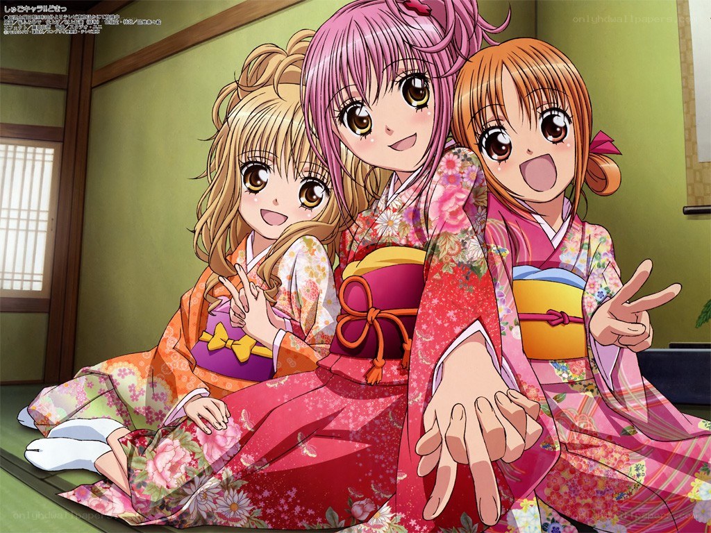 Three girls in kimonos posing