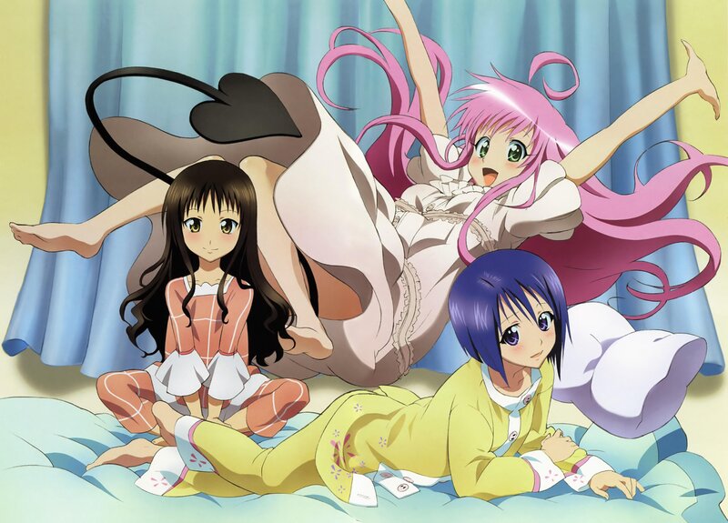 Three girls in pajamas on a bed