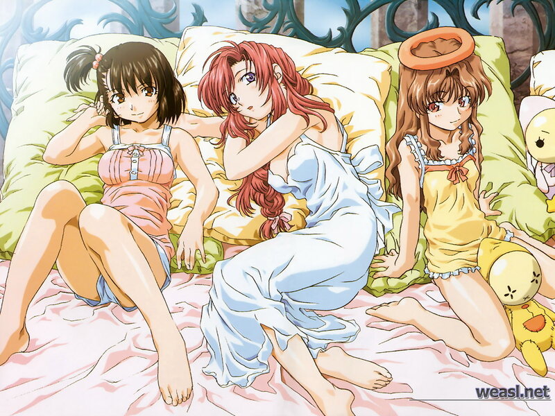 Three girls in pajamas on a bed