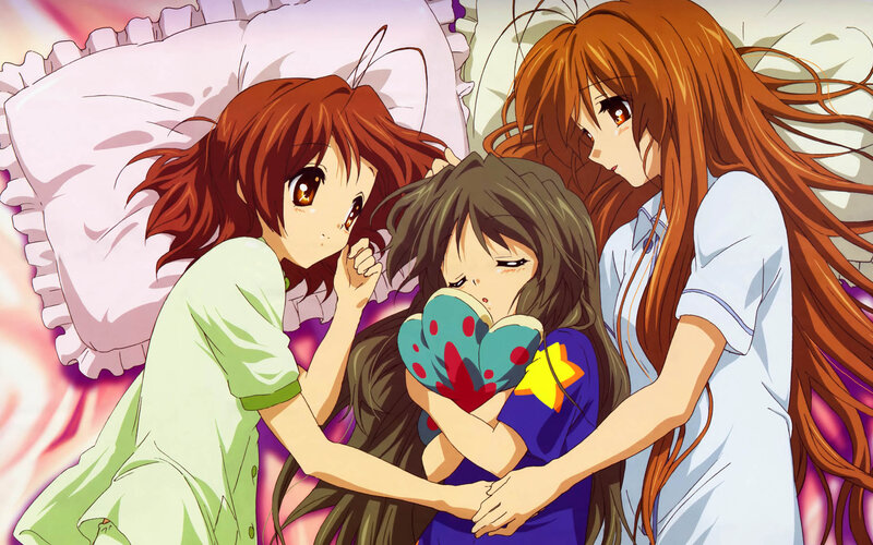 Three girls in pajamas on a bed
