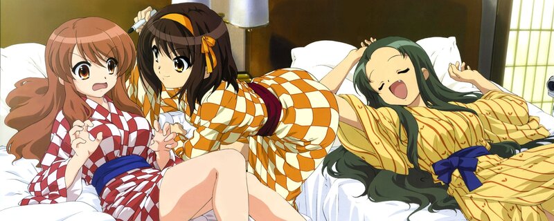 Three girls in pajamas on a bed