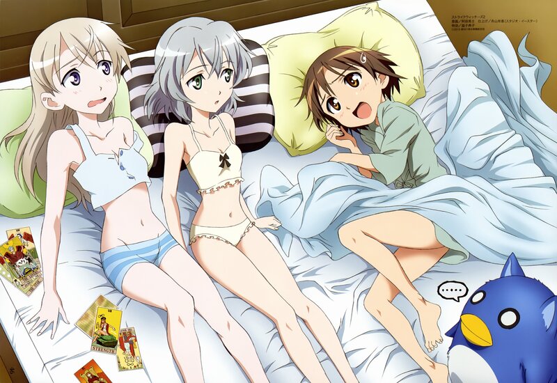 Three girls in pajamas on a bed