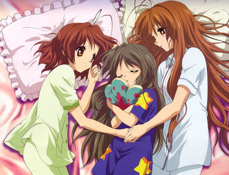 Three girls in pajamas on a bed