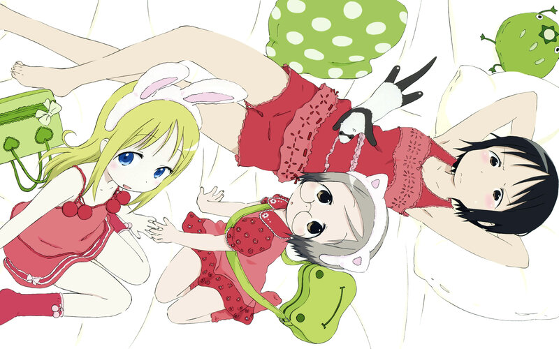 Three girls in pajamas on a bed