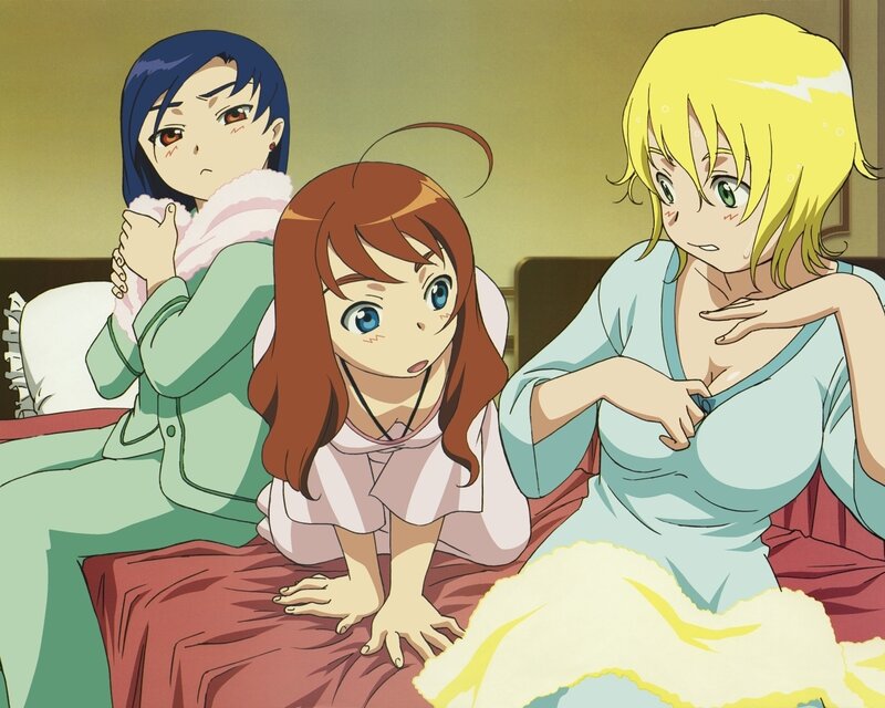 Three girls in pajamas on a bed