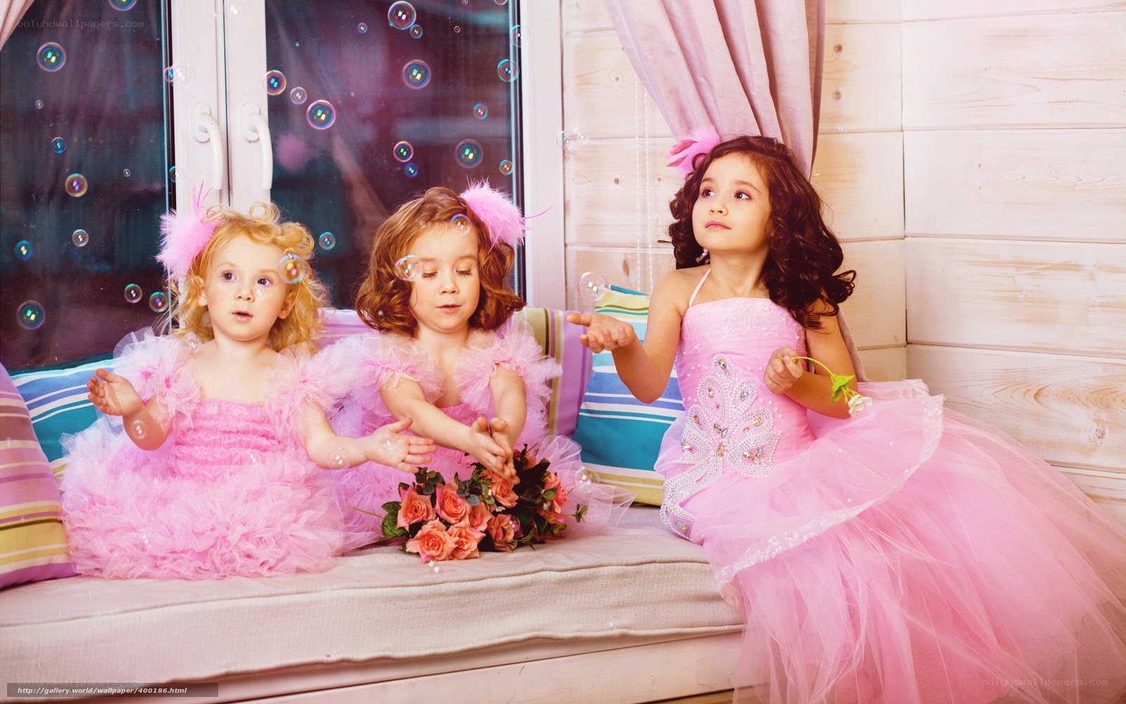 Three girls in pink dresses