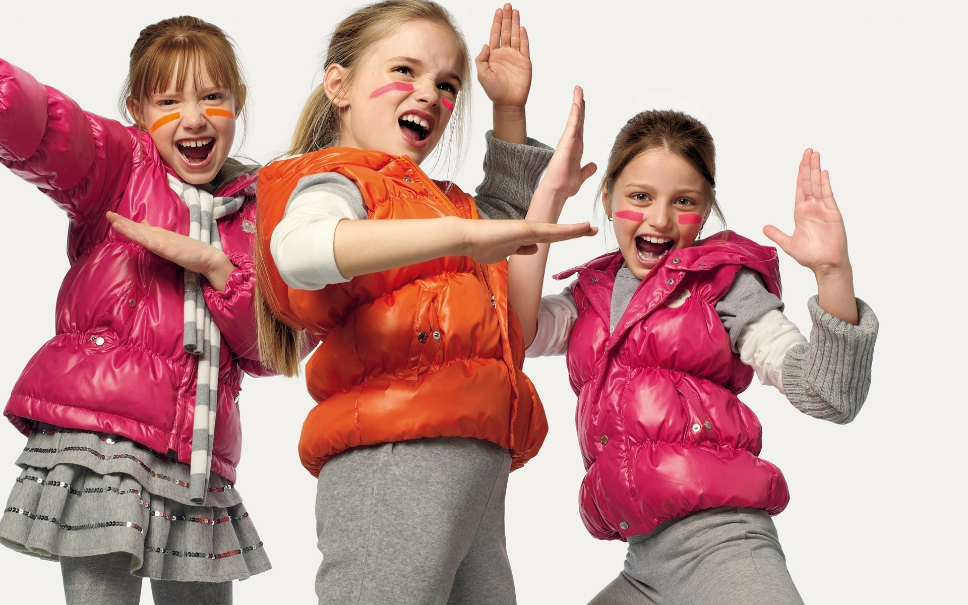 Three girls in puffer vests