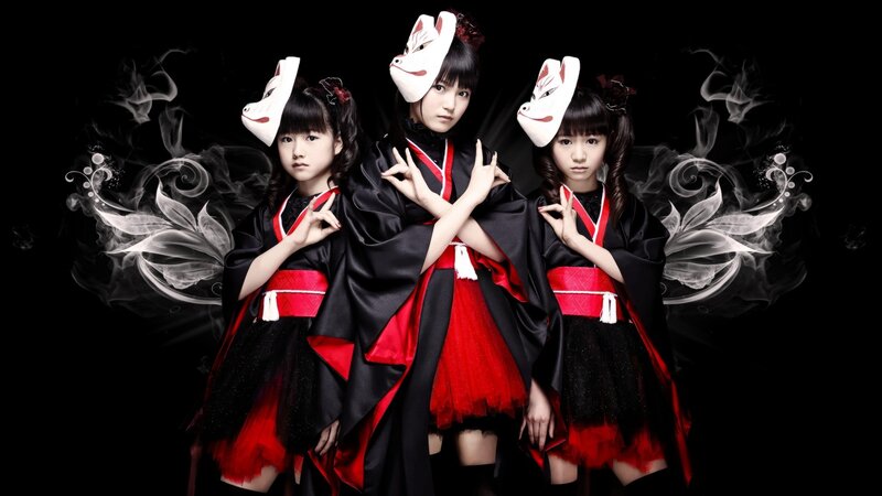 three girls in red and black costumes