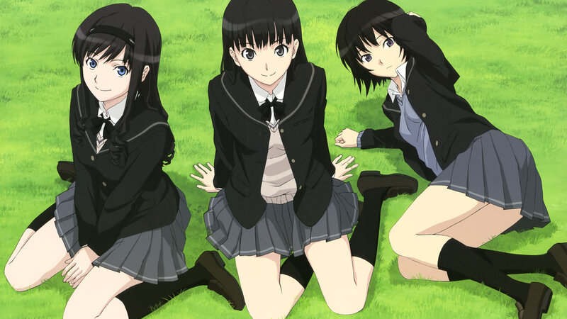 Three girls in school uniforms on grass