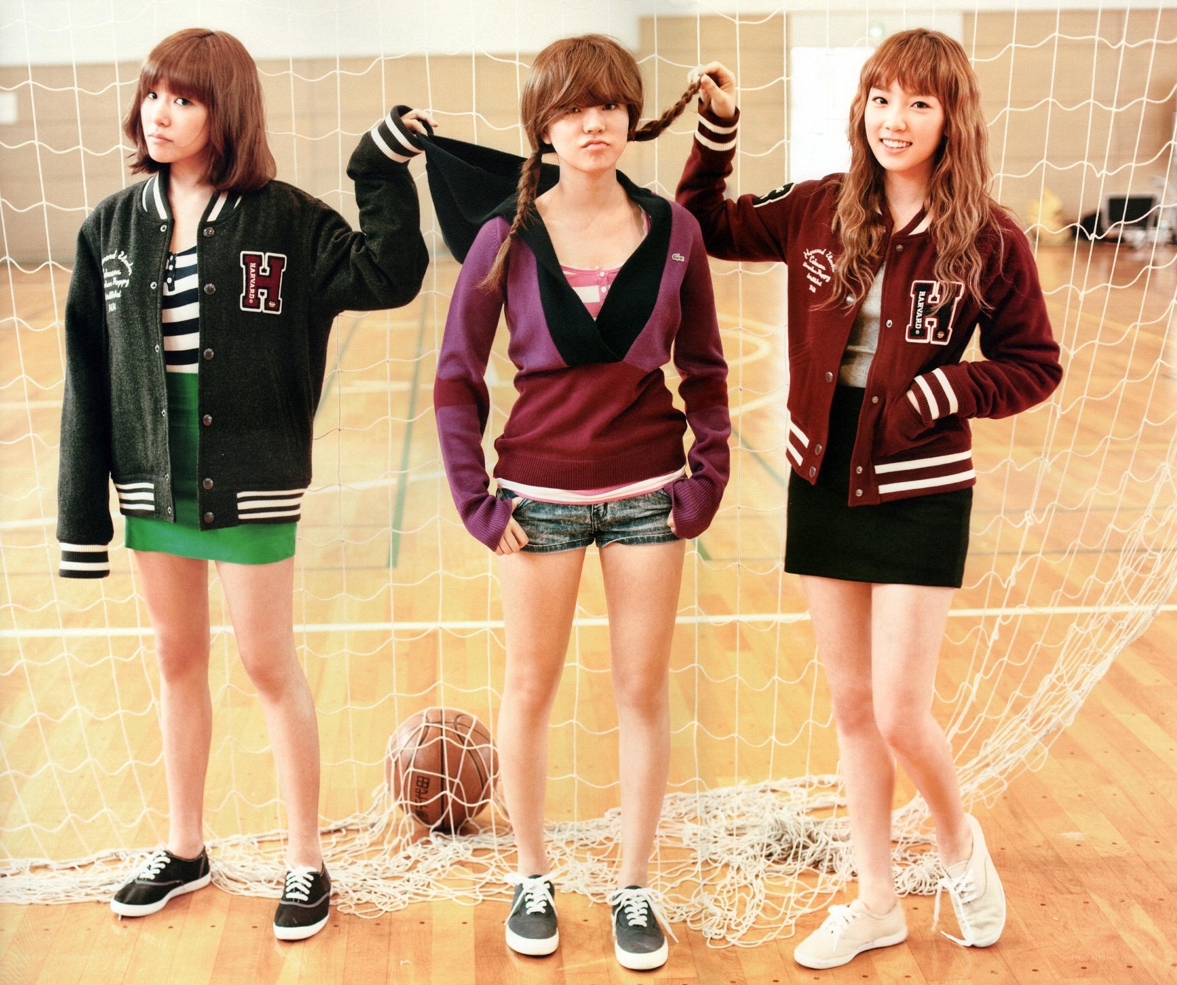 three girls in varsity jackets