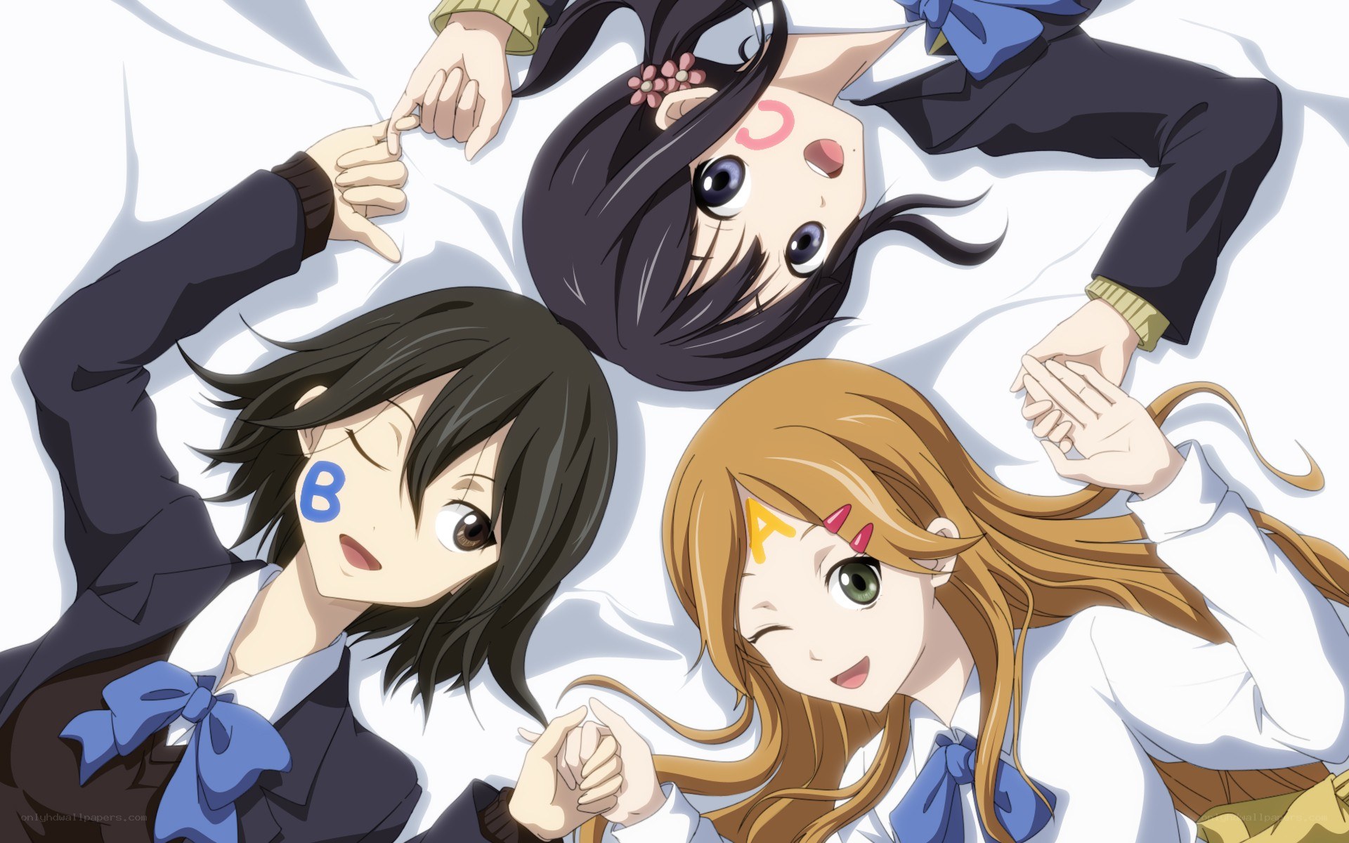 three girls lying on a bed