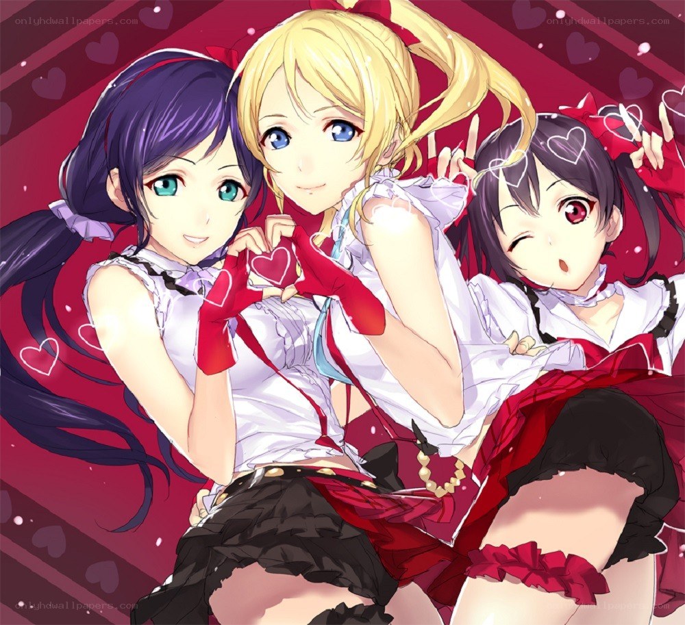 Three girls making heart shapes