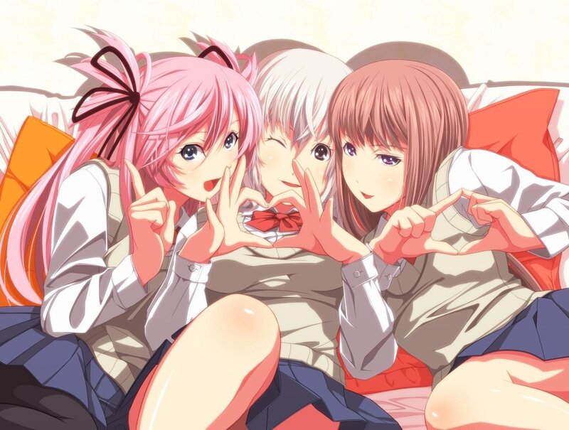 Three girls making heart shapes