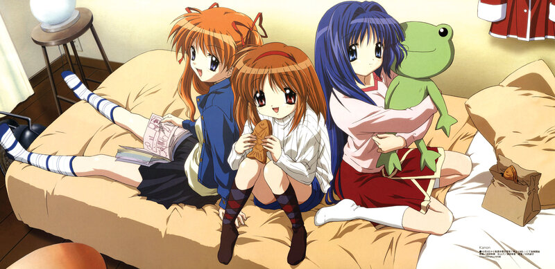 Three girls on a bed with snacks