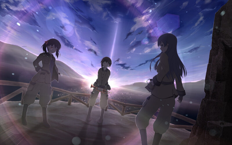 three girls on a cliff at dusk