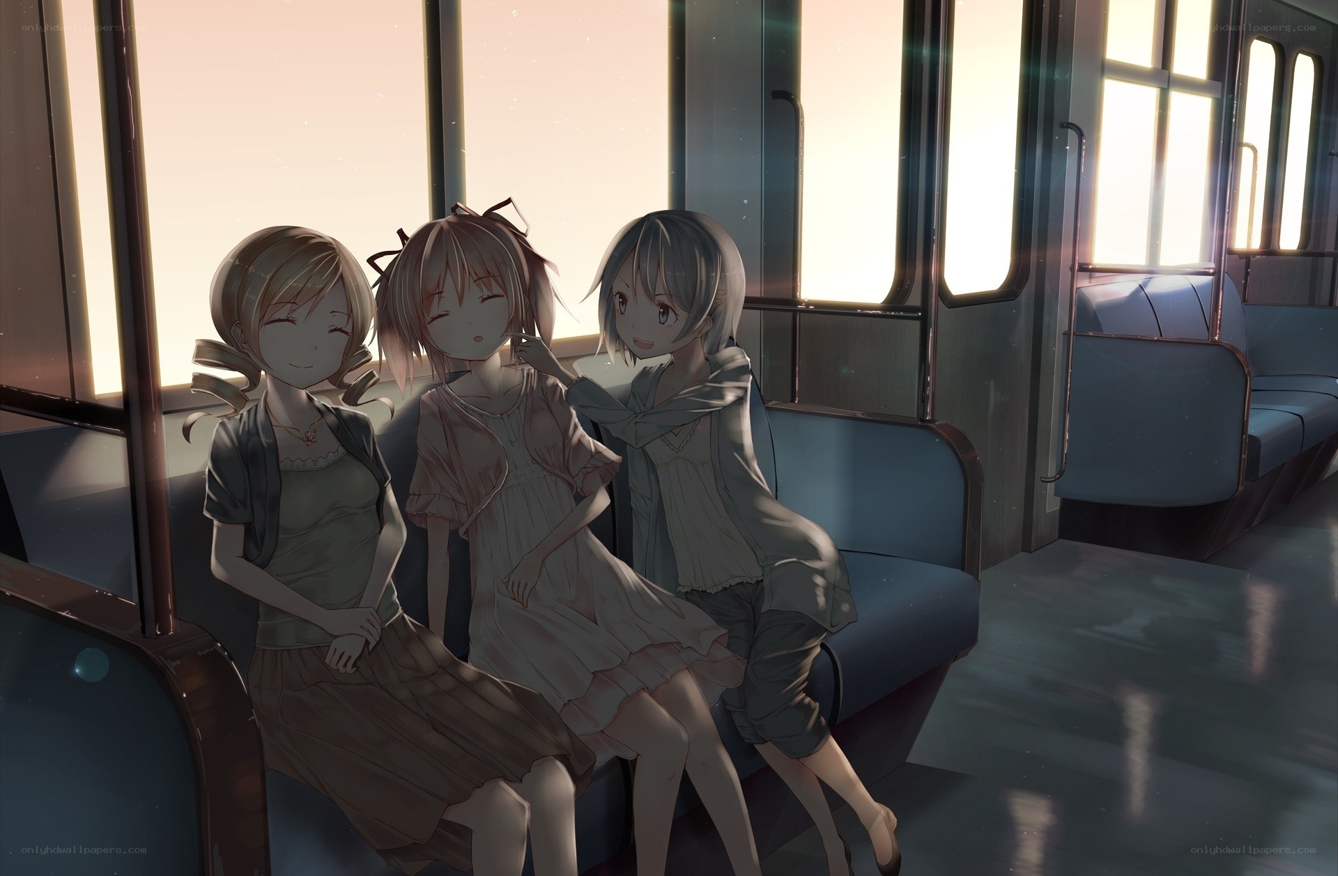 Three girls on a train at sunset