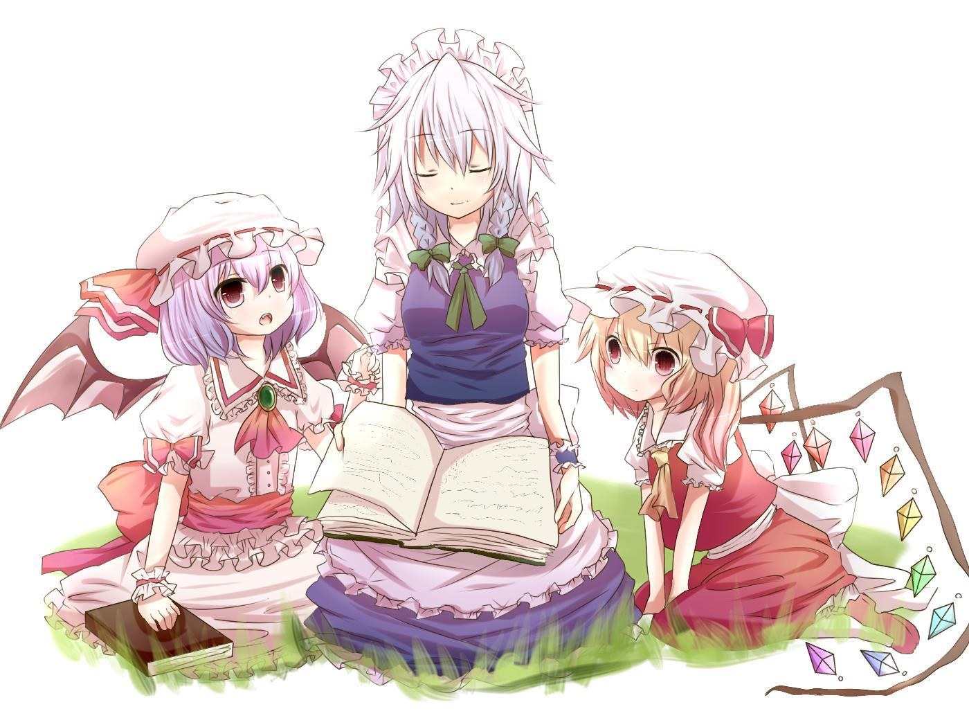 three girls reading in a field