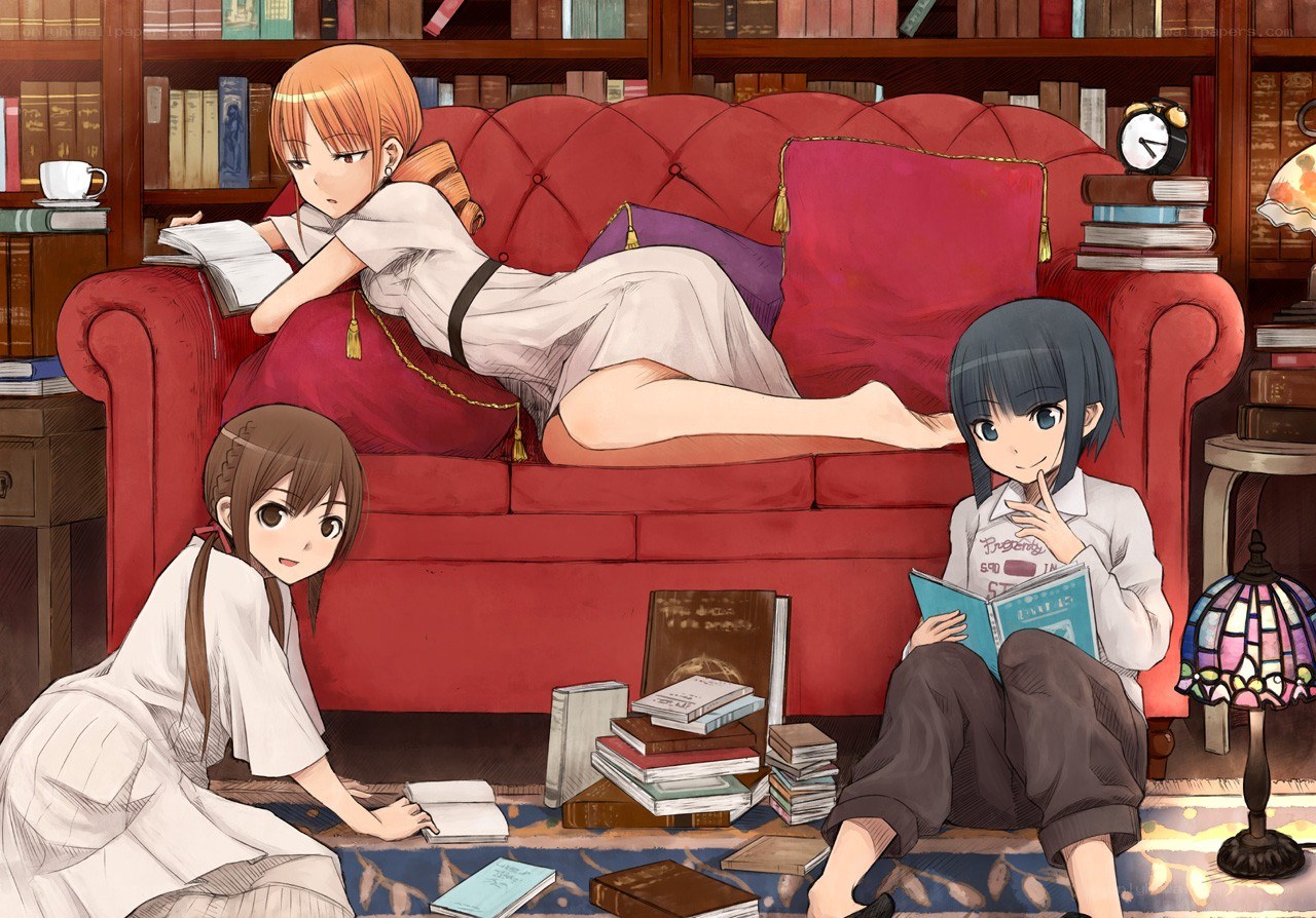 Three girls reading in a library