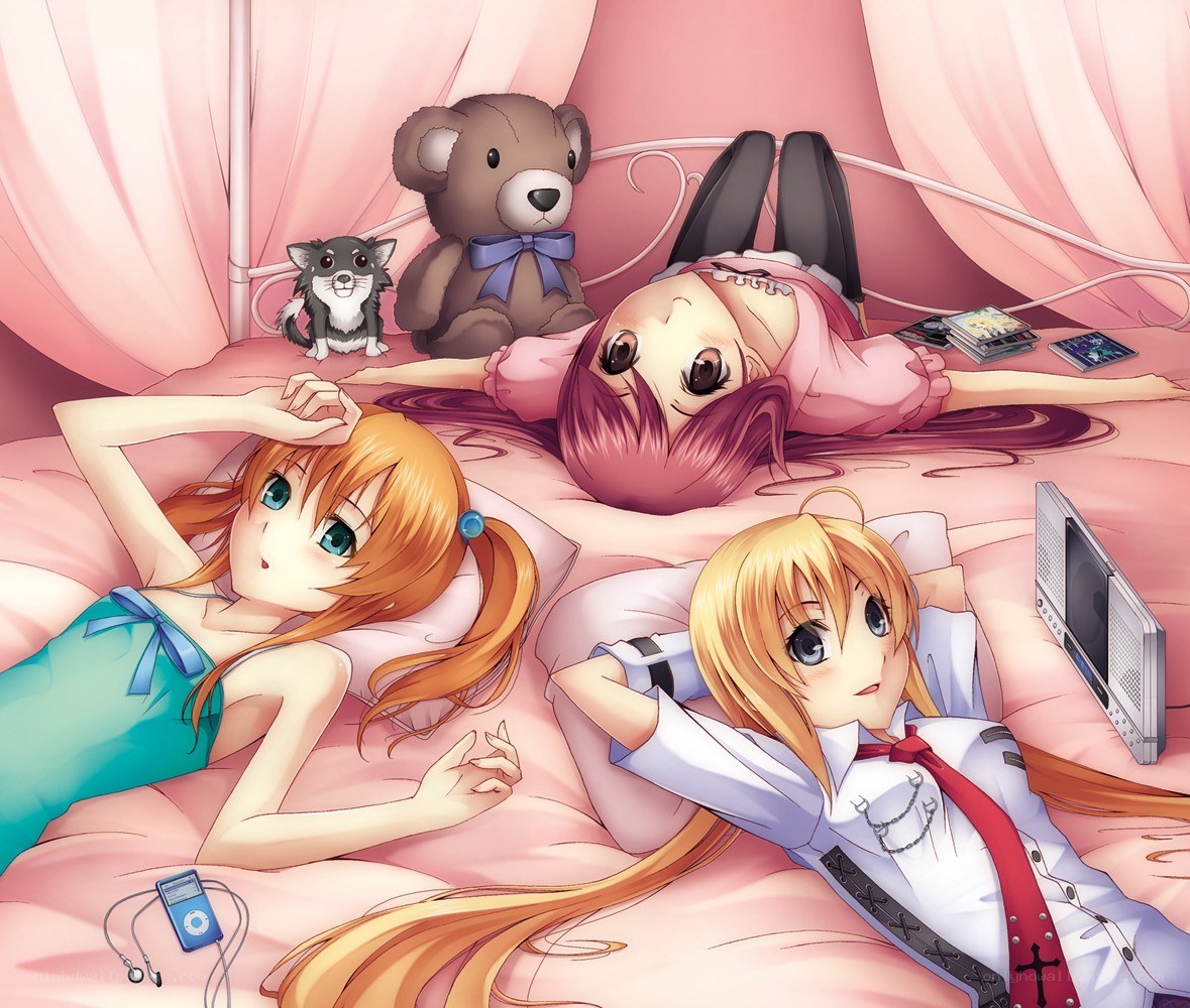 Three girls relaxing on a bed
