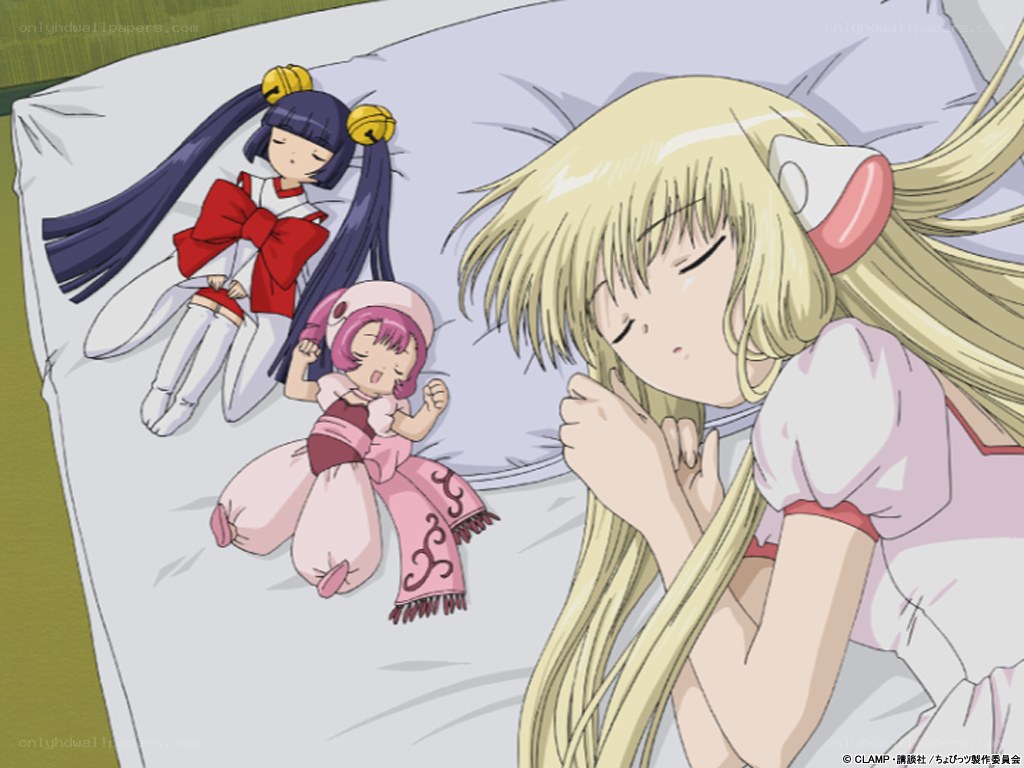 Three girls sleeping on a bed