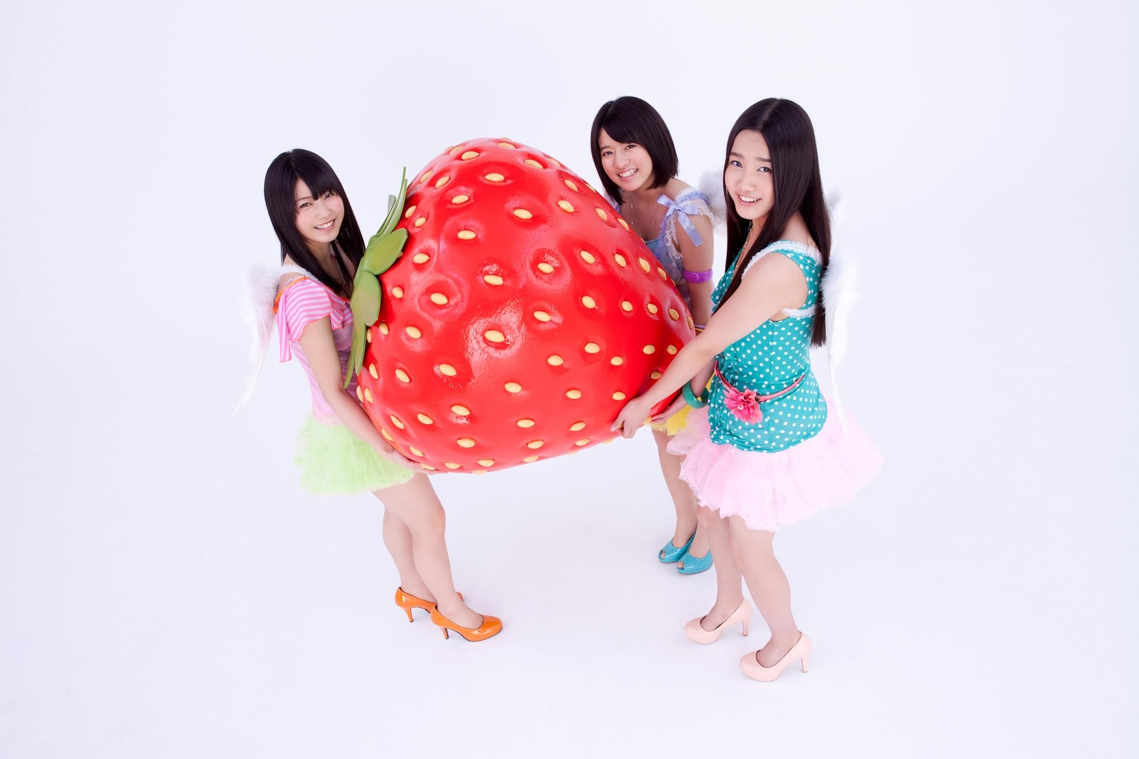 Three girls with a giant strawberry