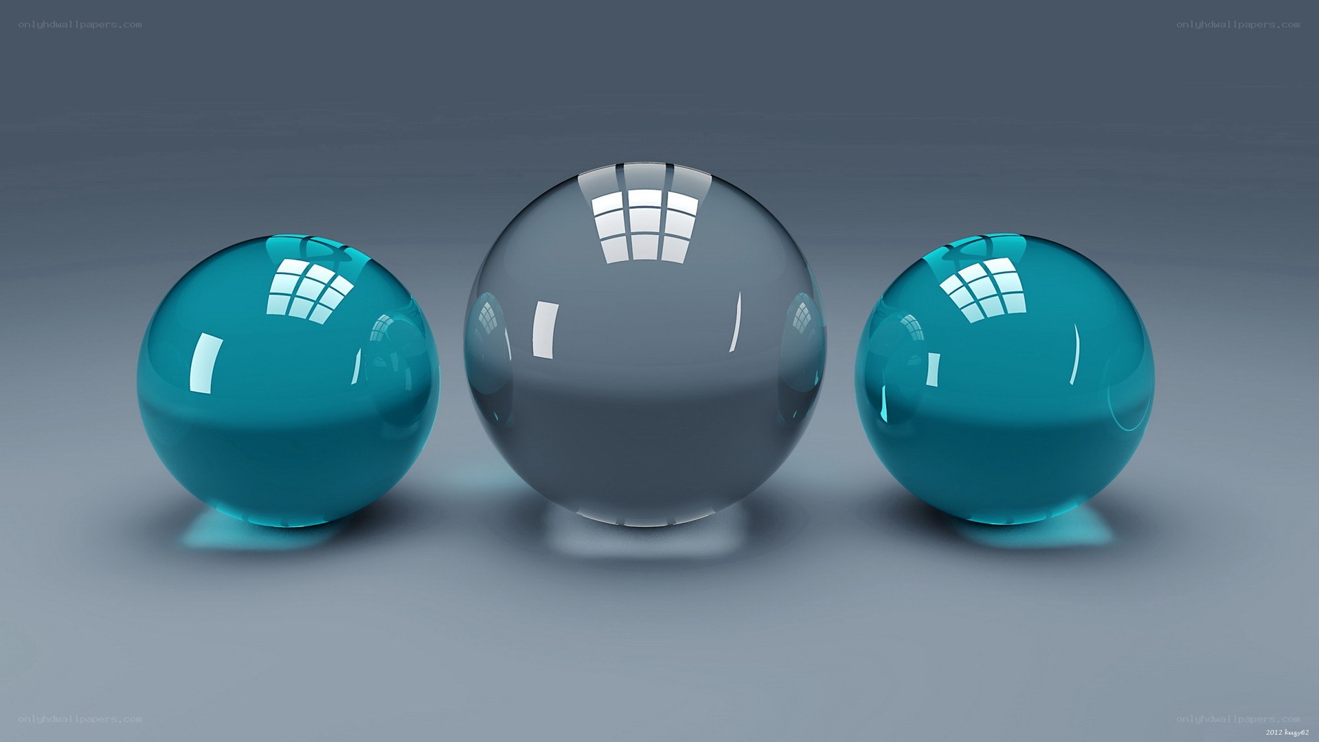 Three glass spheres on gray surface