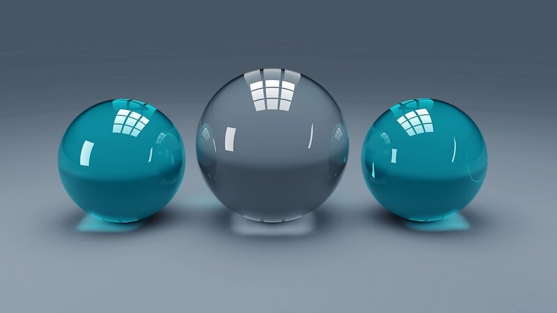 Three glass spheres on gray surface