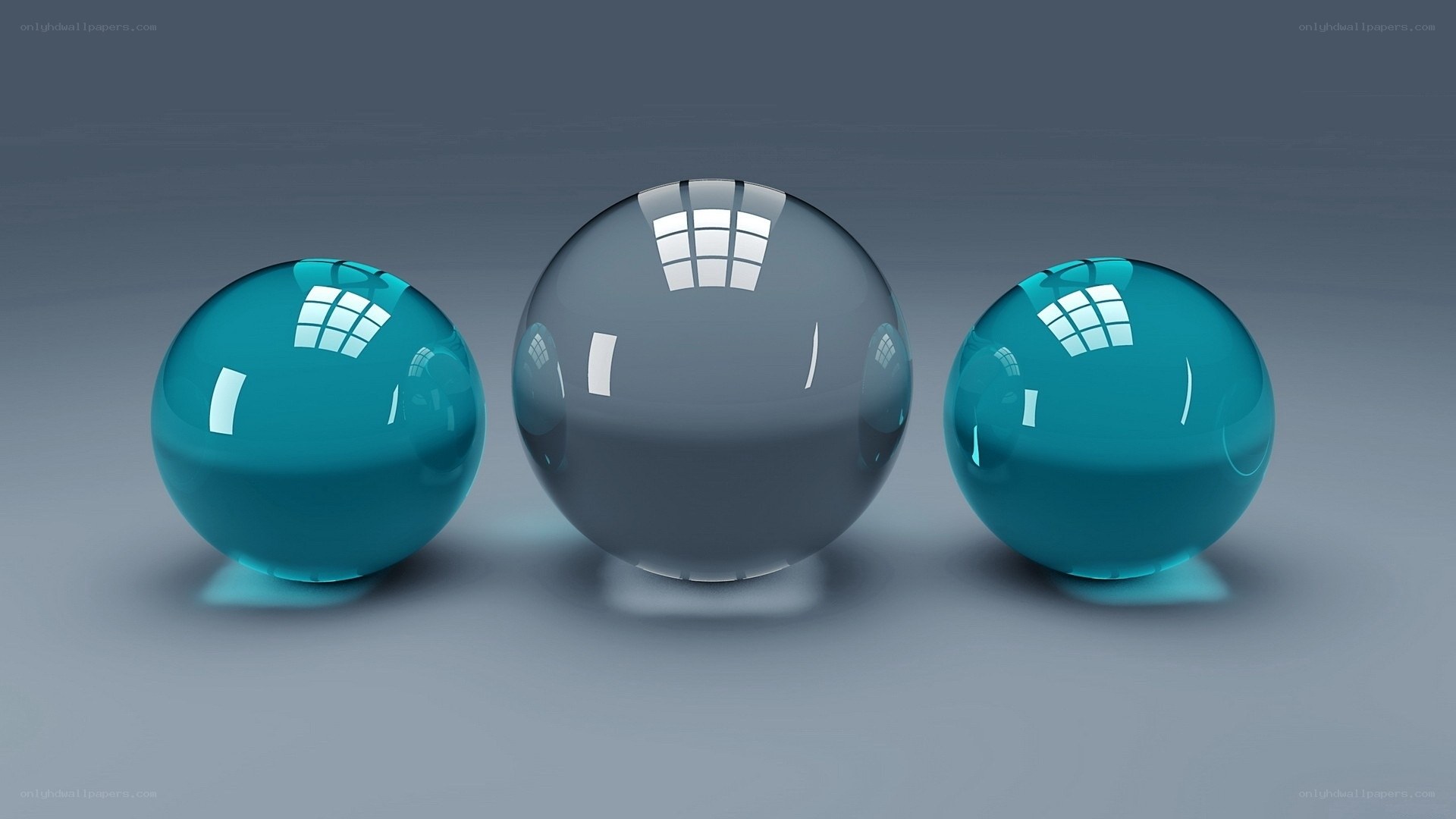Three glass spheres on gray surface
