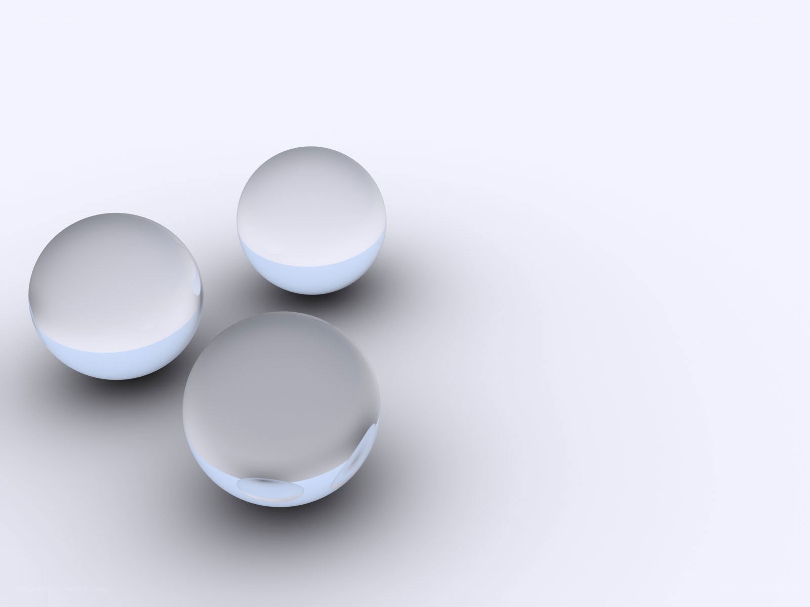 Three glass spheres on white