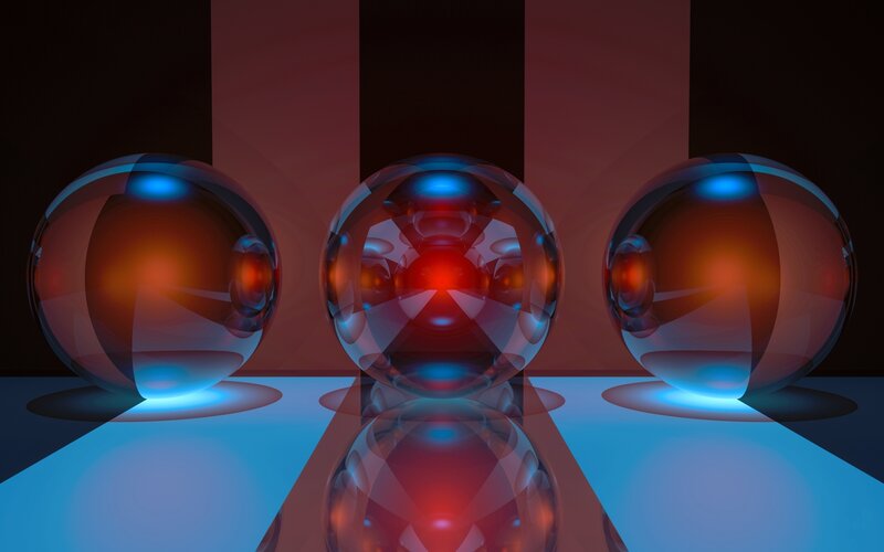 Three glass spheres with light reflections