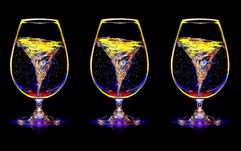 Three glasses with liquid vortex