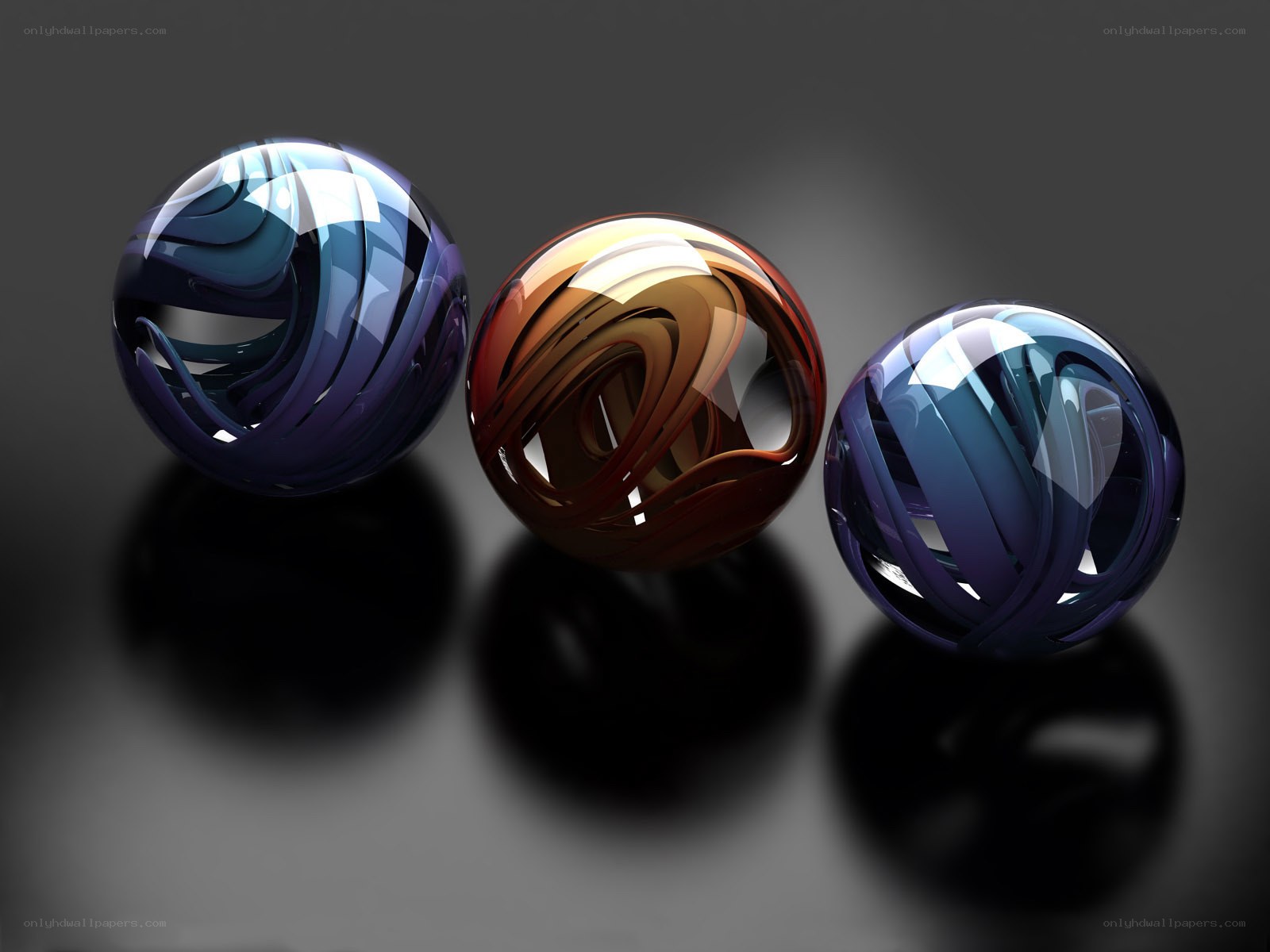 Three glossy spheres with swirl patterns