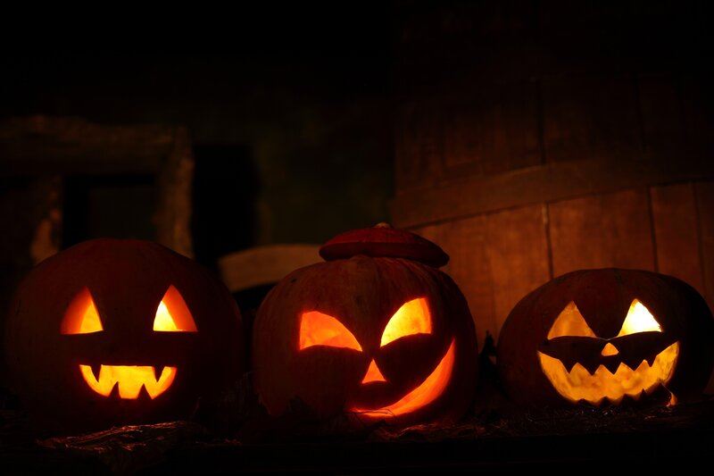 Three glowing jack-o'-lanterns