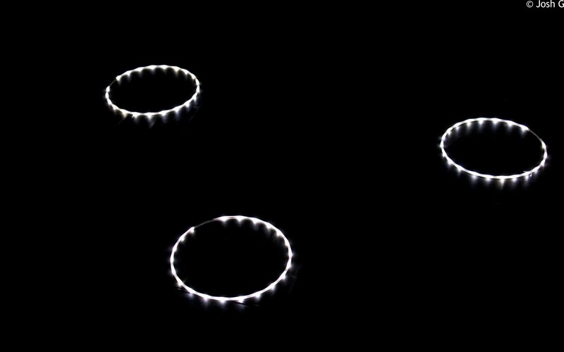 Three glowing rings on black