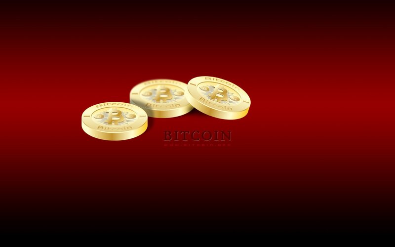 three golden bitcoin coins