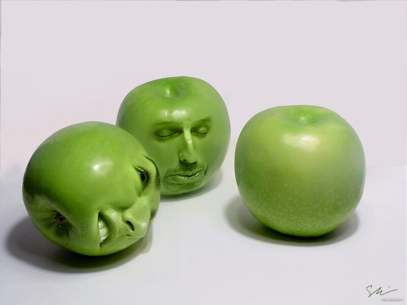 Three green apples with faces