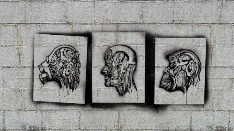 three head sculptures on wall