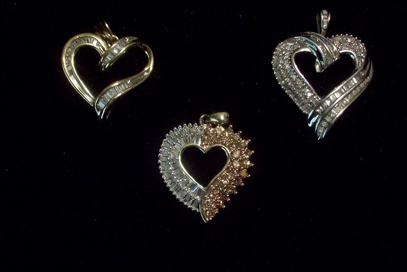 Three heart-shaped diamond pendants