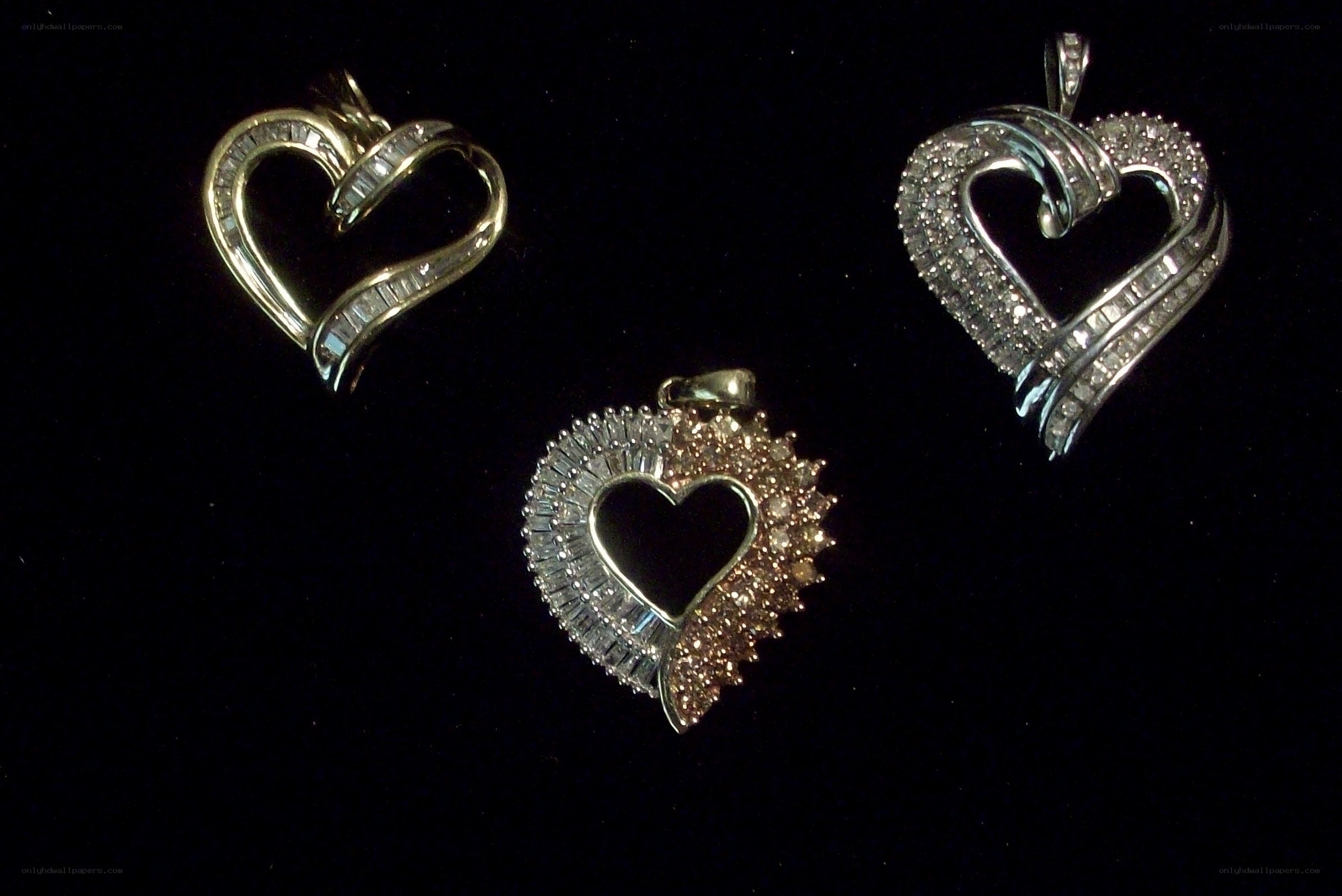 Three heart-shaped diamond pendants