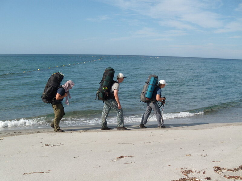 Three Hikers on Beach