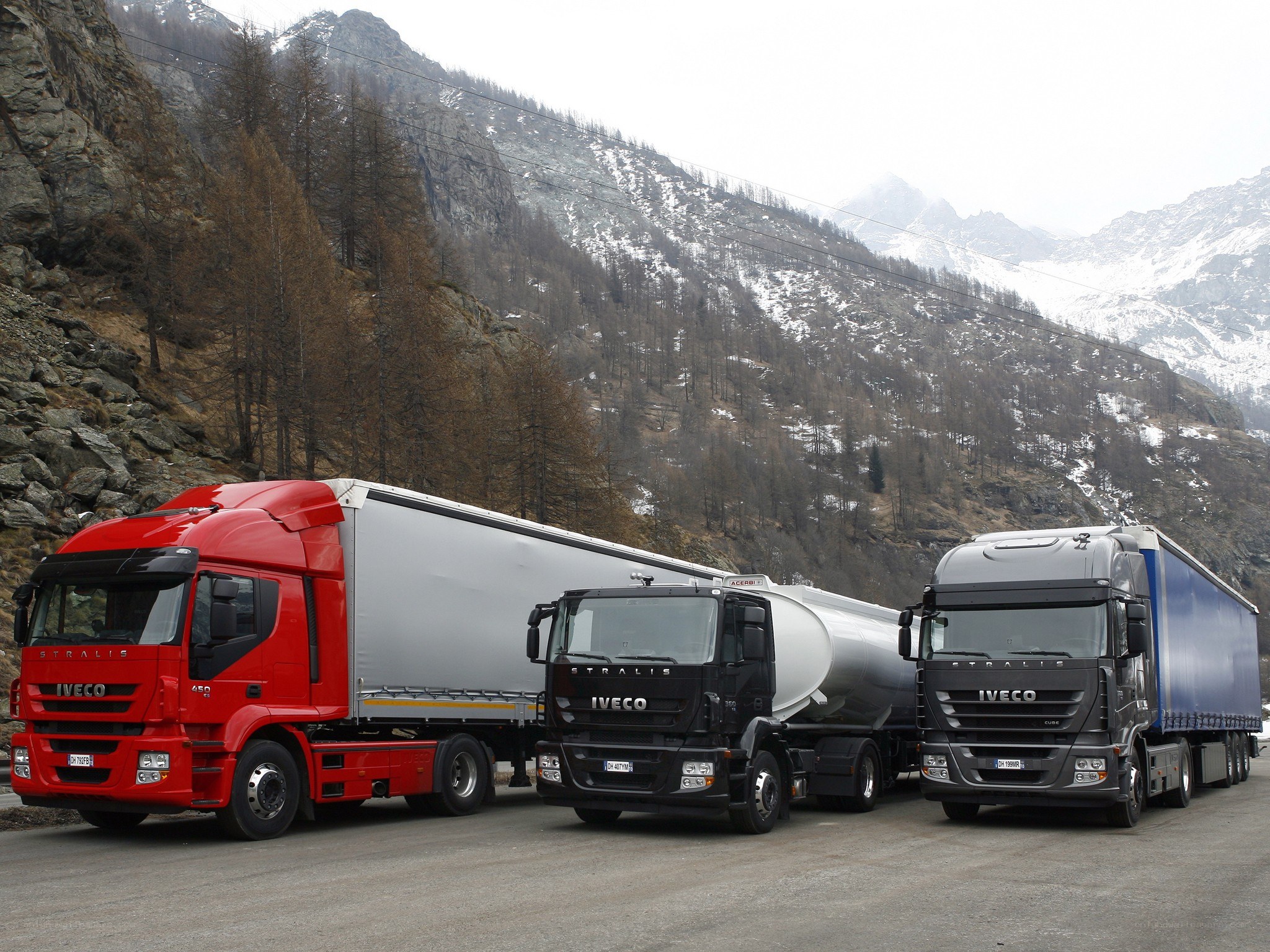 Three Iveco trucks in mountain pass