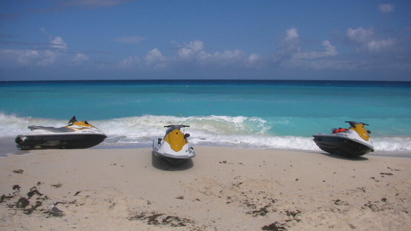 Three Jet Skis on Beach