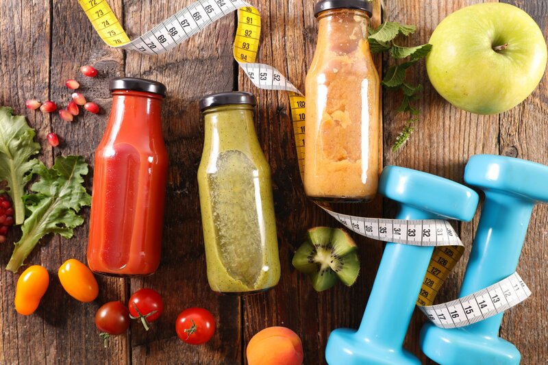 Three Juice Bottles on Wood