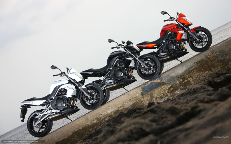 Three Kawasaki motorcycles on a ramp