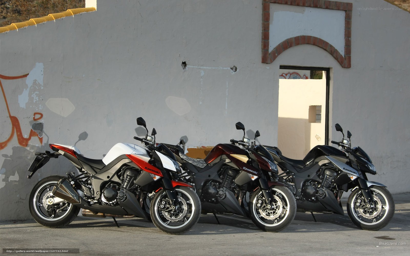 Three Kawasaki motorcycles parked