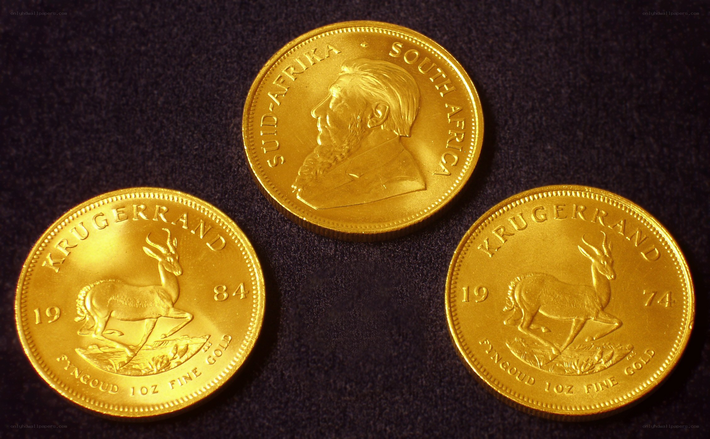 Three Krugerrand gold coins