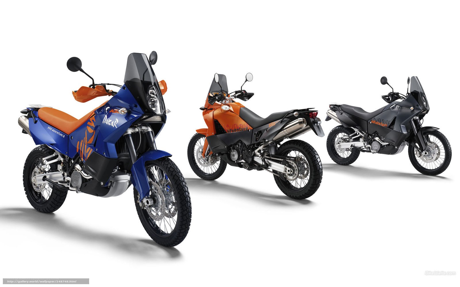 Three KTM adventure motorcycles