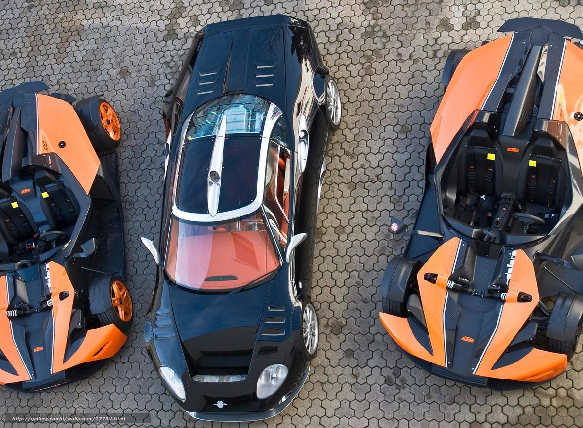 Three KTM cars on pavement